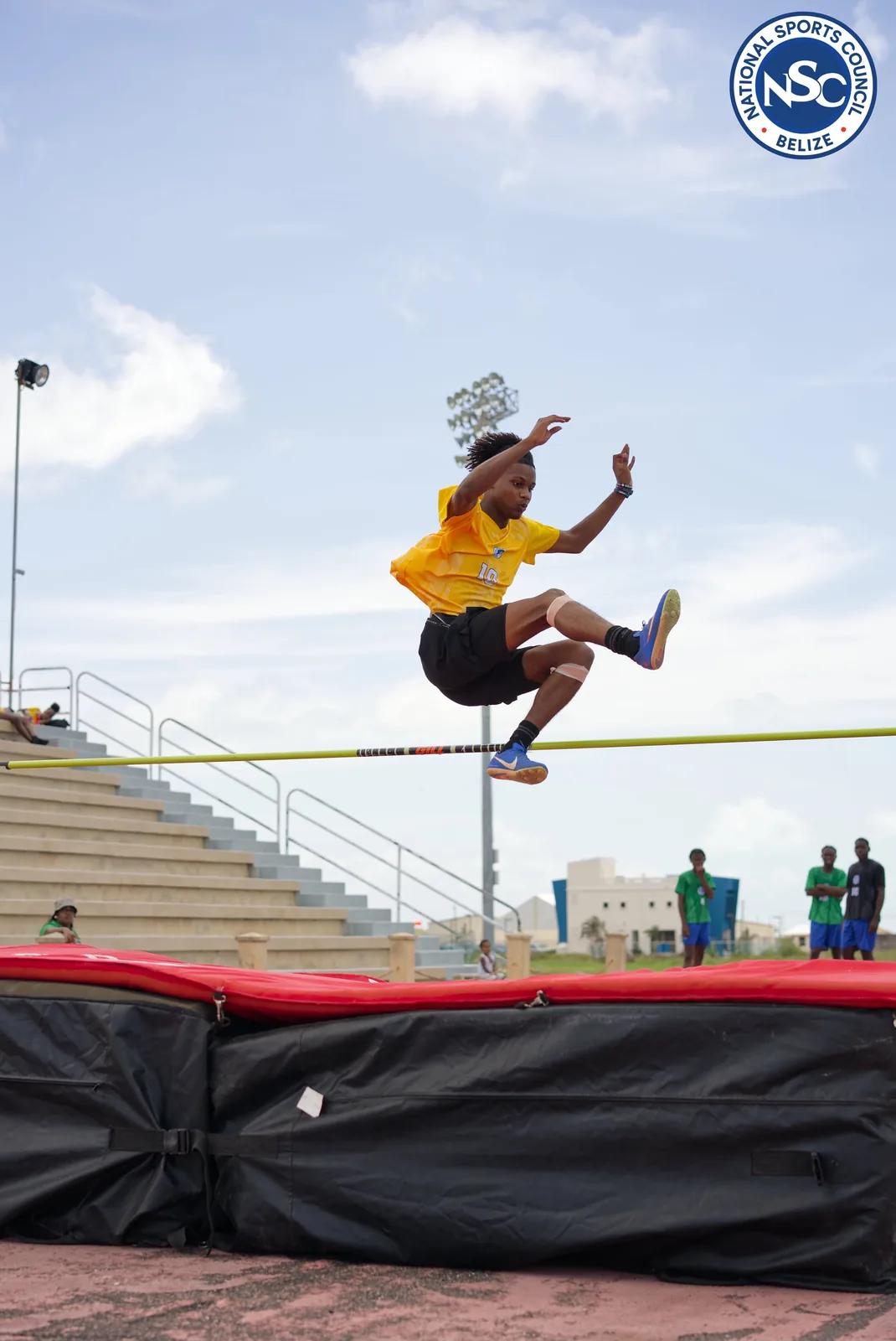 A high jump athlete clearing the bar at the NSC Super Nationals